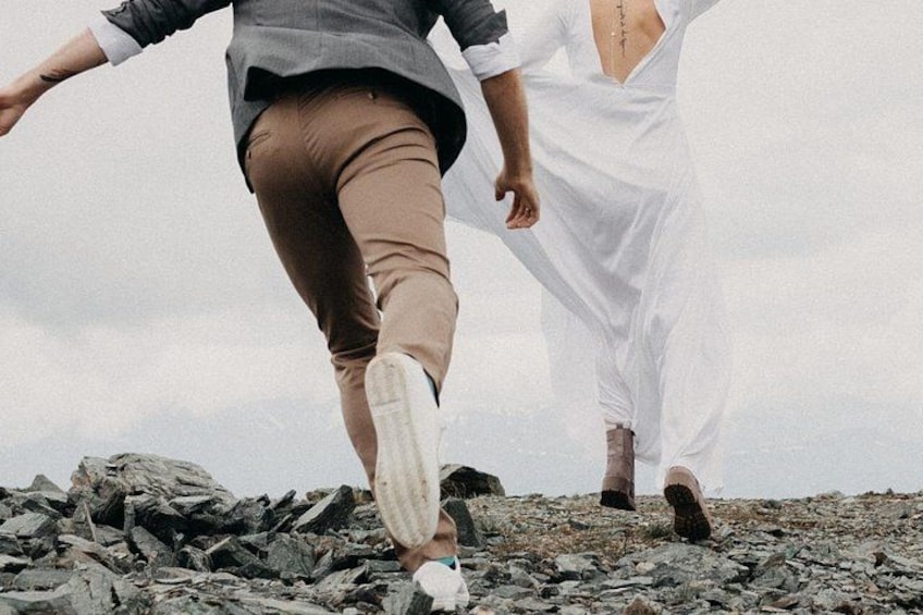 Two people walking on a rocky terrain. 2
