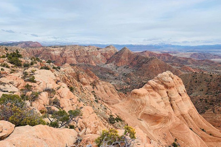 A rugged mountain landscape with prominent rock formations and sparse vegetation. 5