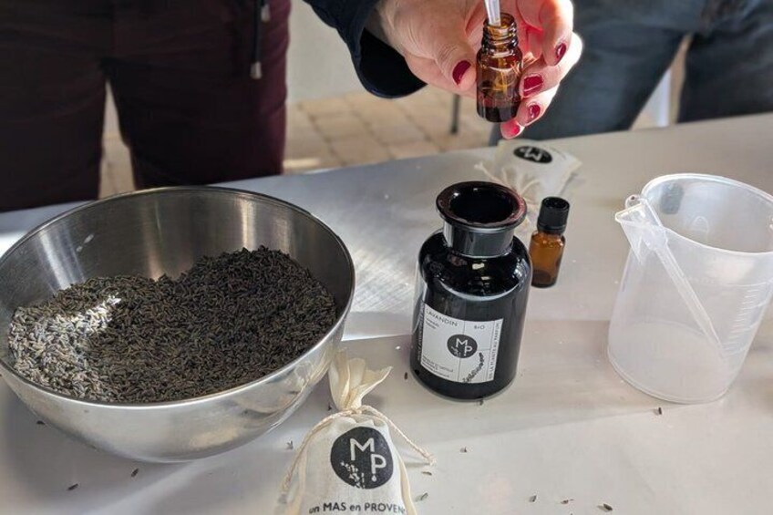 A person pouring a liquid from a dropper into a measuring cup. 2