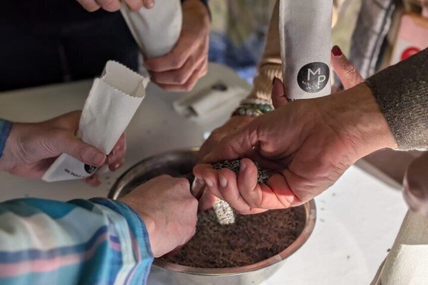 People handling coffee beans in a bowl. 4