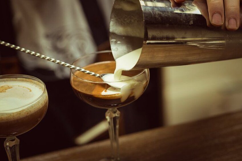 A person pouring milk into a glass. 4