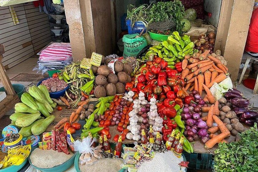 A variety of fresh vegetables and grains displayed at a market stall. 2