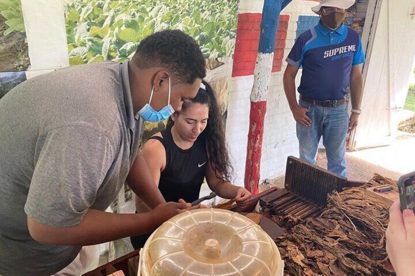 People working with wooden planks, a plastic container, and a red and white striped pole. 5