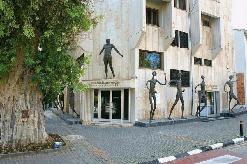 A building with a sculpture of a man playing basketball. 2