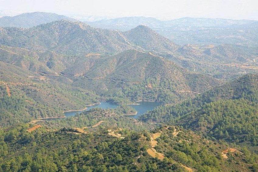 A mountainous landscape with a lake and winding roads. 3
