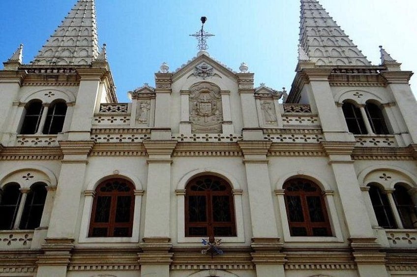 A historic building with ornate architecture, including a central pediment and two symmetrical towers. 4