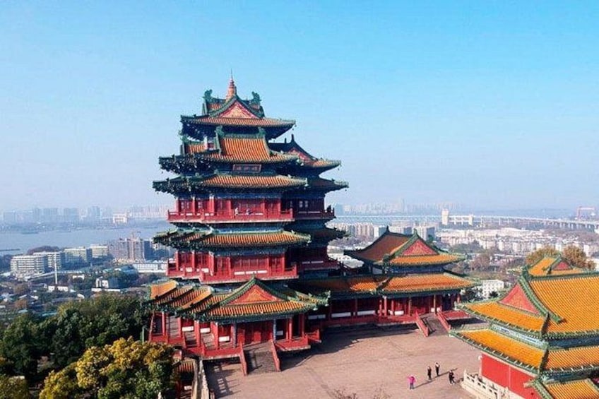 A multi-tiered pagoda with traditional architecture, surrounded by a clear sky and a distant cityscape. 3