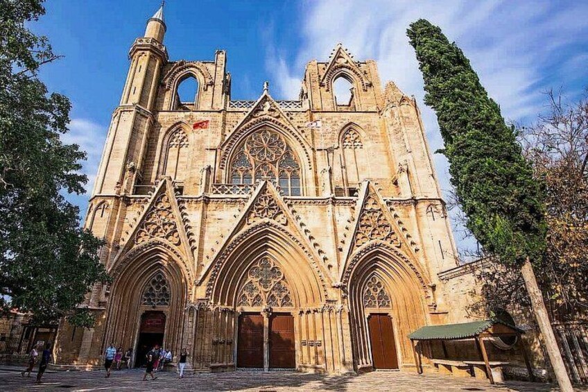 A Gothic cathedral with intricate stonework, large arched windows, and a tall spire. 4