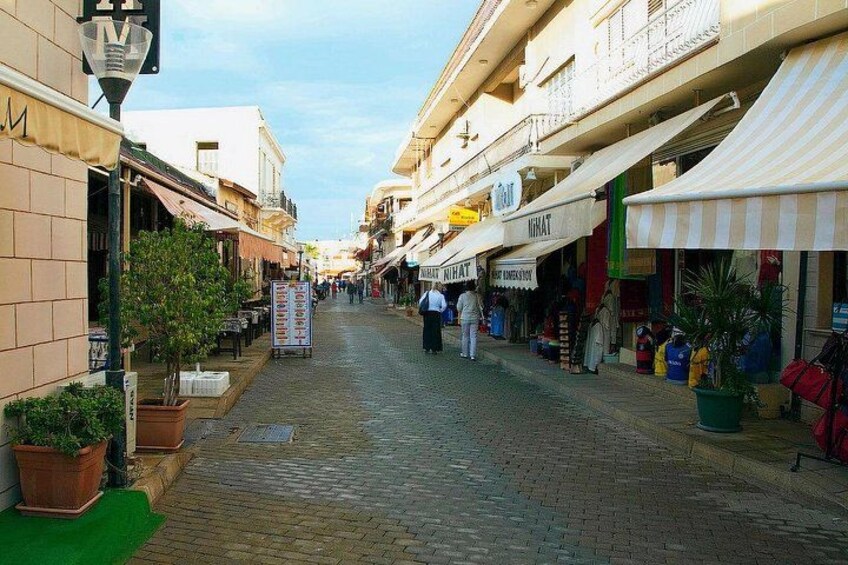 A cobblestone street lined with shops and buildings. 3