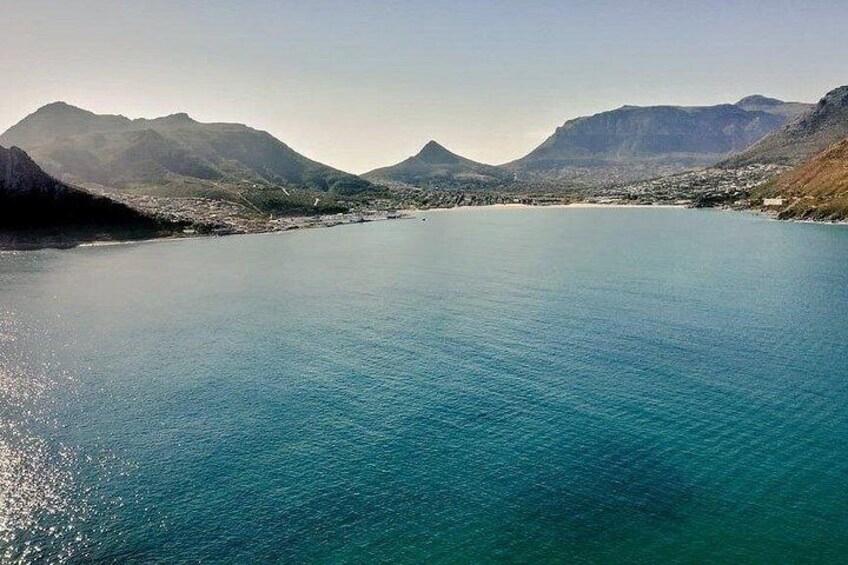 A large body of water surrounded by mountains. 4