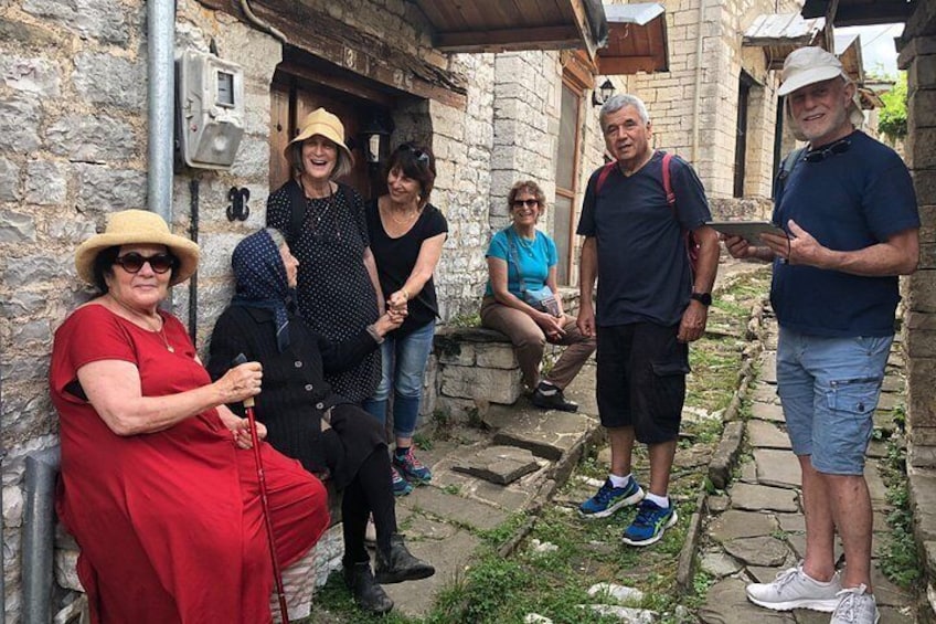 A group of people in a stone building with a rustic exterior. 5