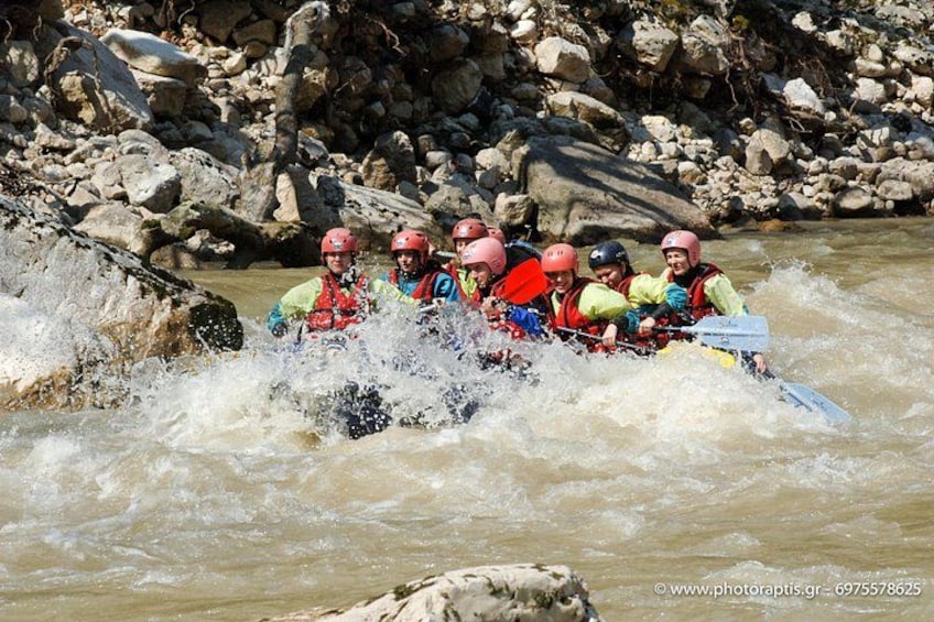A group of people rafting on a river surrounded by rocks. 2