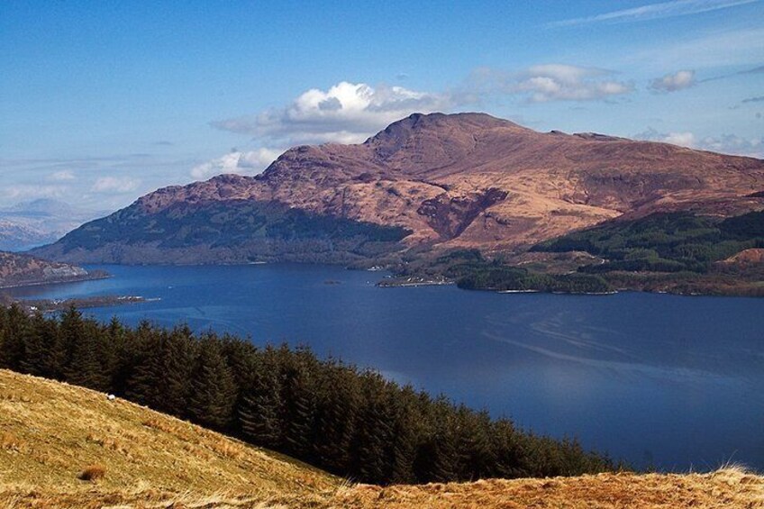 A mountain range, a large lake, and a forested area. 1