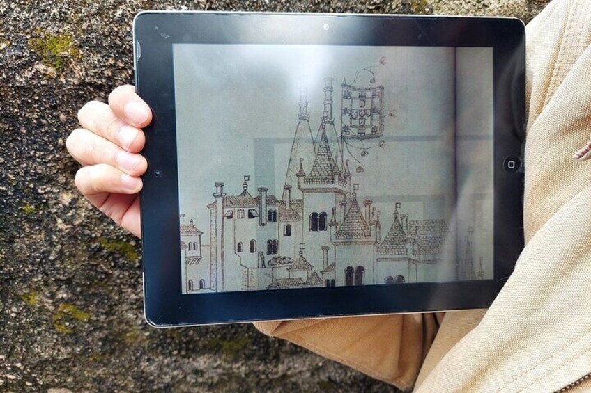 Une personne tenant une tablette sur laquelle est affiché un dessin d’un château. 4