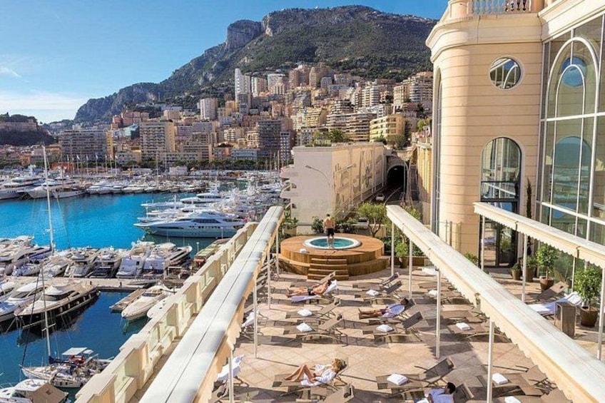 A marina with boats, a pool, and a cityscape in the background. 2