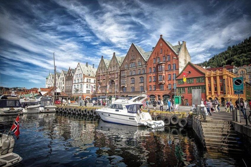 A harbor with boats, a red brick building, and a white boat in the foreground. 2