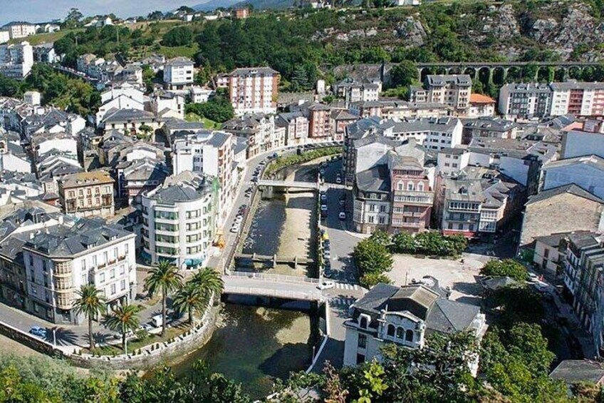 A coastal cityscape with a mix of modern and historic buildings, a prominent bridge, and a waterfront area. 5
