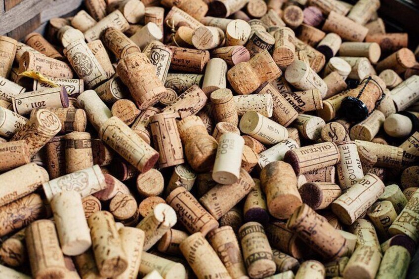 A collection of wine corks with various labels and text. 2