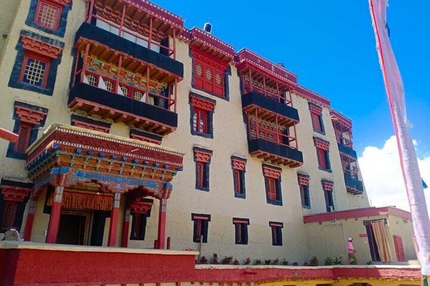 A multi-story building with traditional architecture, balconies, and decorative elements. 5