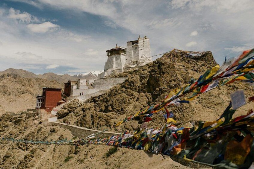 A monastery on a mountain with a clear sky. 1