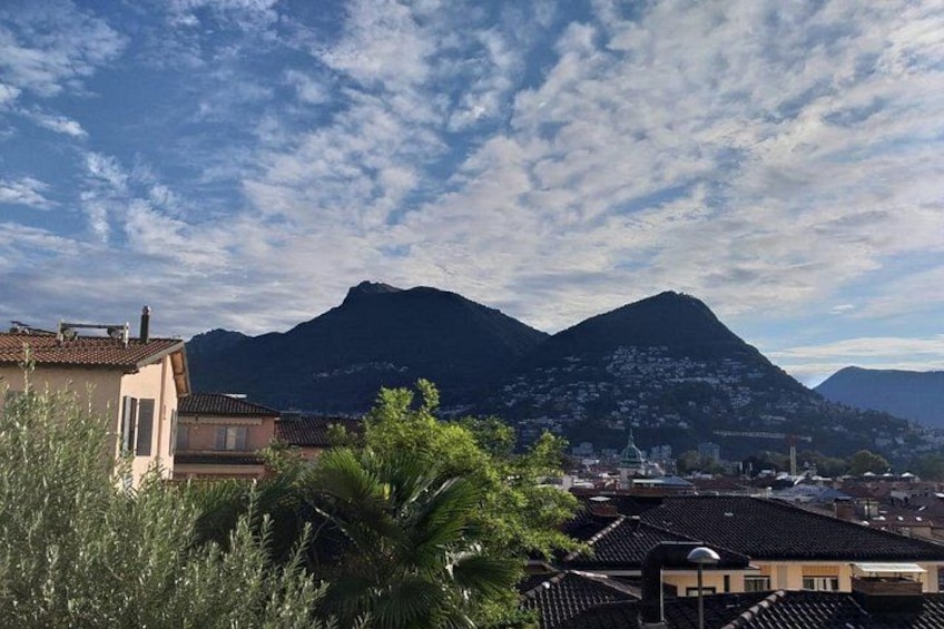 A mountainous landscape with buildings and a clear sky. 2