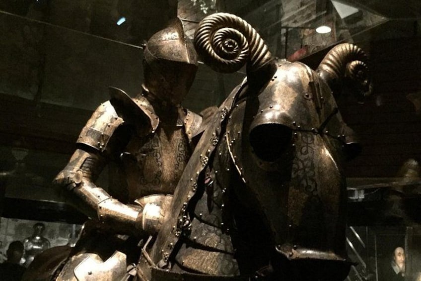 A historical armor suit with intricate designs and large, curved horns. 2