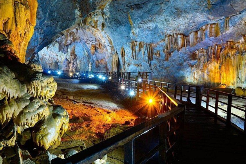A cave with stalactites and a wooden walkway. 1