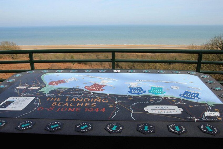 Un mapa histórico titulado 'Las Playas del Desembarco 6-8 de junio de 1944' con escala y flechas indicadoras. 2