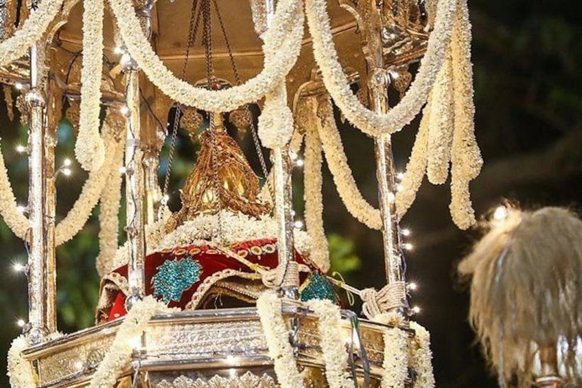 A decorated carriage with intricate designs and garlands. 5