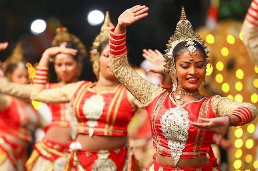 A group of dancers in traditional attire performing a dance. 2