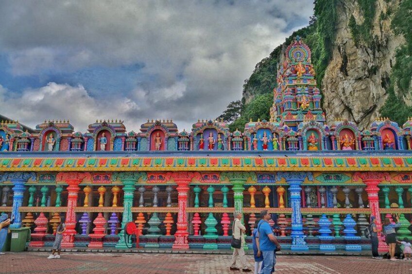A colorful temple with intricate architecture and a mountainous backdrop. 3