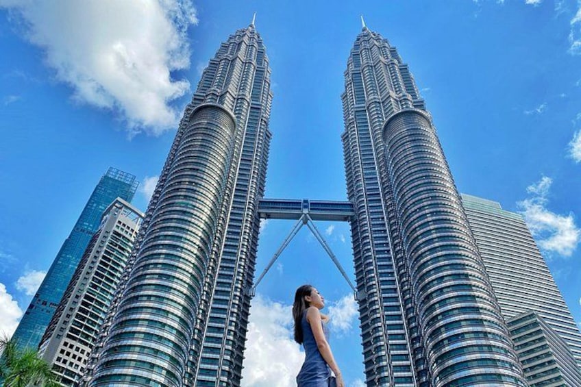 The Petronas Twin Towers with a person standing in front of them. 1