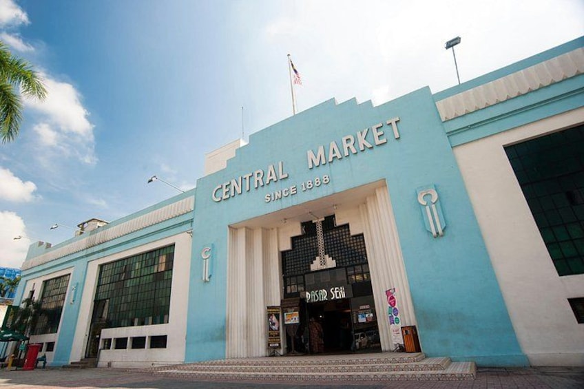 A building with a sign reading 'CENTRAL MARKET SINCE 1888' and a flag above it. 2