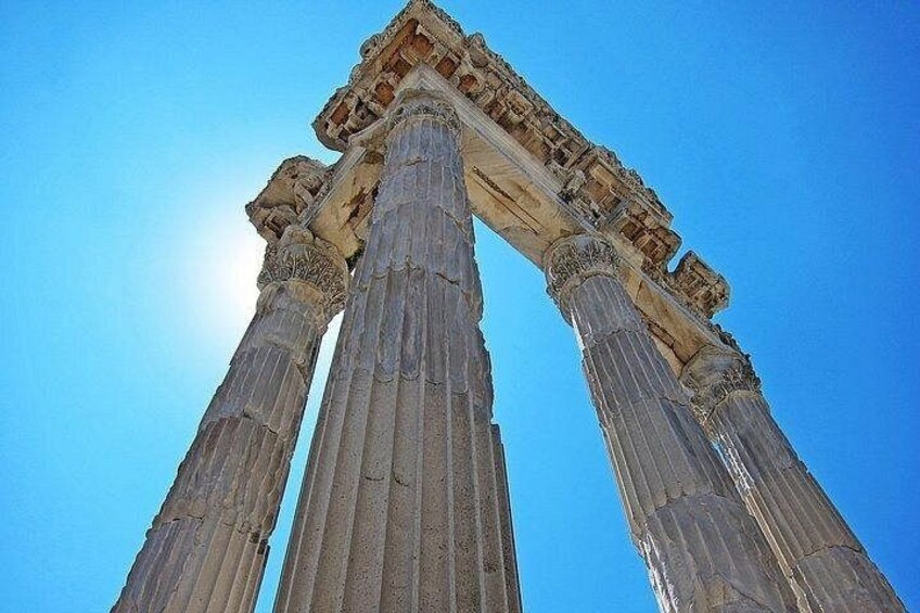 Ancient Greek columns with a clear blue sky in the background. 2