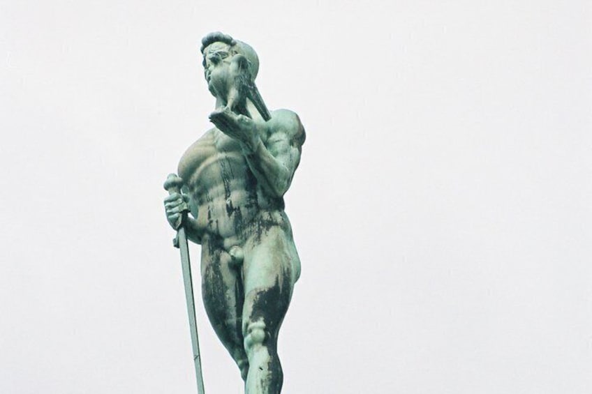 A bronze statue of a muscular figure holding a spear. 2