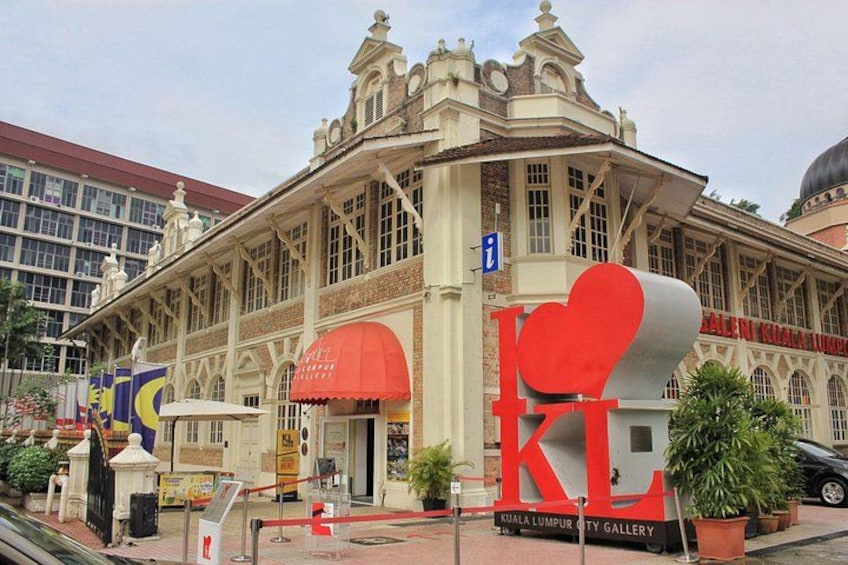 A building with ornate architecture and a large red heart-shaped sign. 1