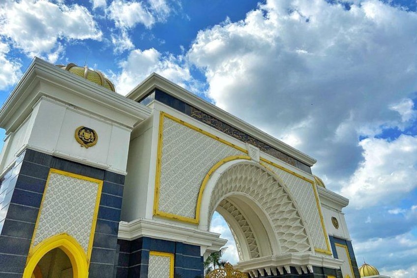 A grand building with a large arched entrance, intricate patterns, and a blue and white color scheme. 4