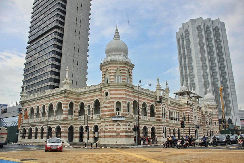 A historic building with domes and arches, surrounded by modern skyscrapers. 5