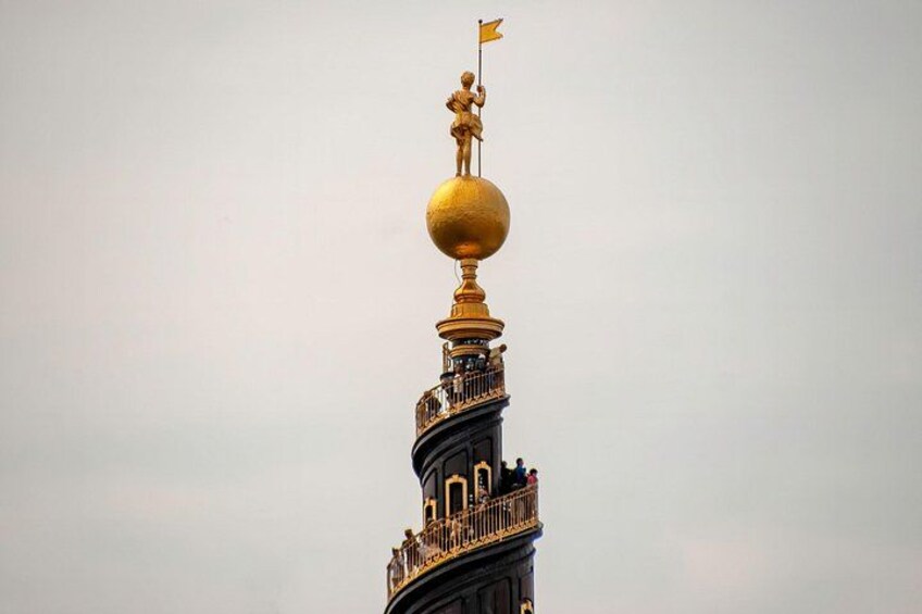 A tower with a golden sphere and a flag on top. 2