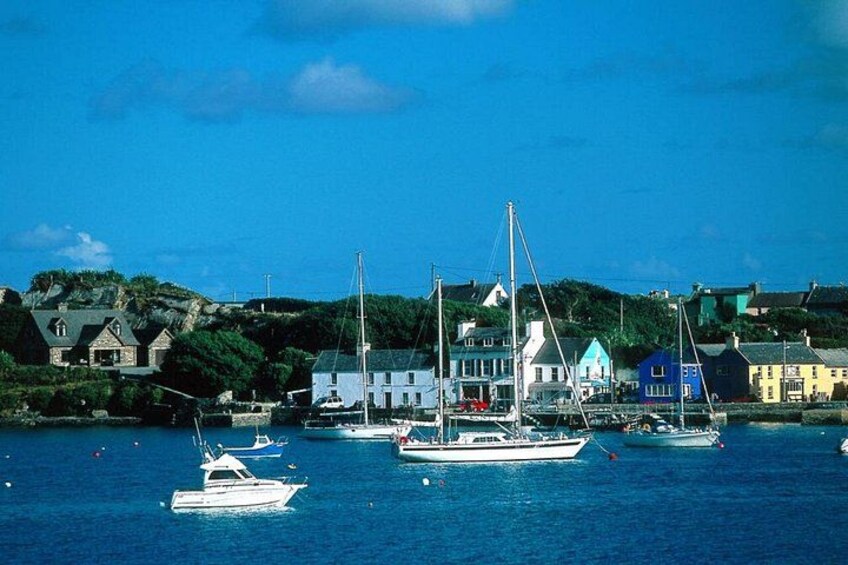 A harbor with sailboats, a lighthouse, and colorful buildings. 3