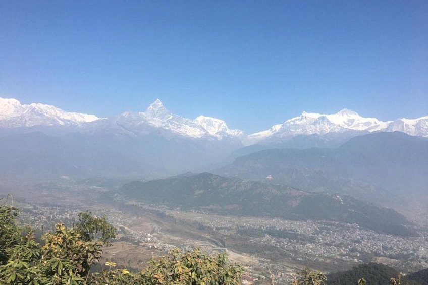 A mountainous landscape with snow-capped peaks and a valley below. 1