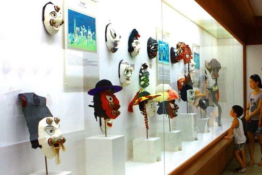 A museum display of various traditional masks. 3