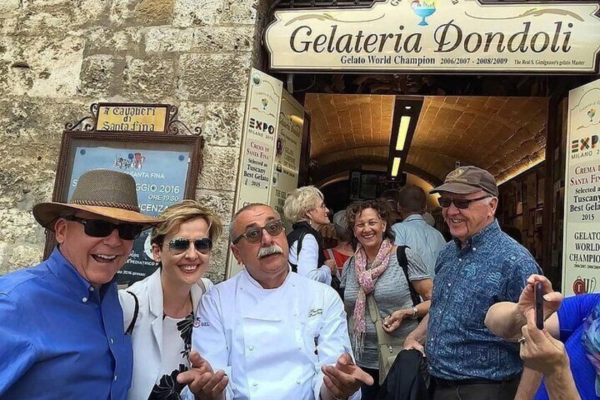 Gelateria Dondoli, a gelato shop with a signboard and a stone wall backdrop. 2