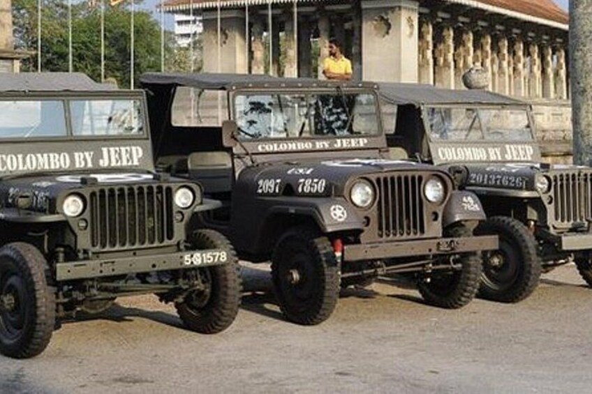 Three military-style vehicles with 'Colombo by Jeep' written on them. 3