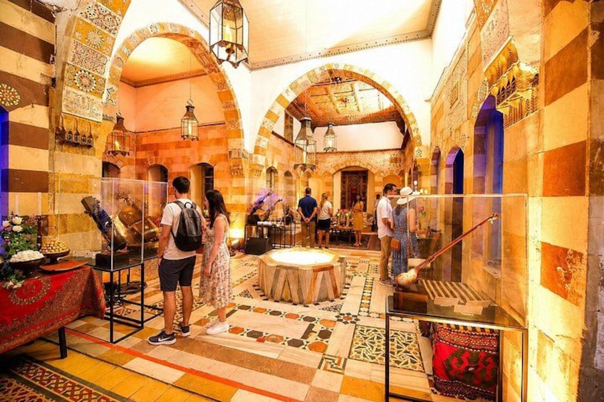 A historical building with arches, tiled floors, and exhibits. 4