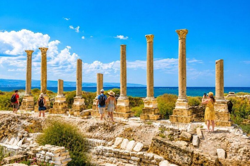 Ancient ruins with columns and tourists. 4