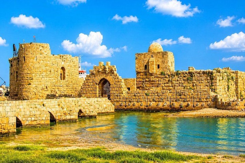 A historic stone fortress with towers and a moat. 2