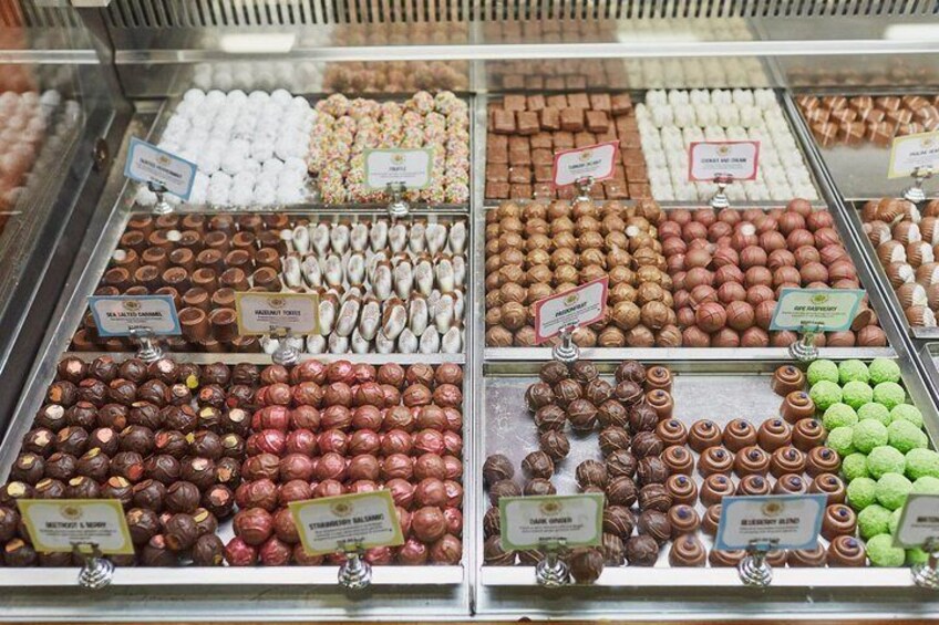 A display case of assorted chocolates and confections. 5