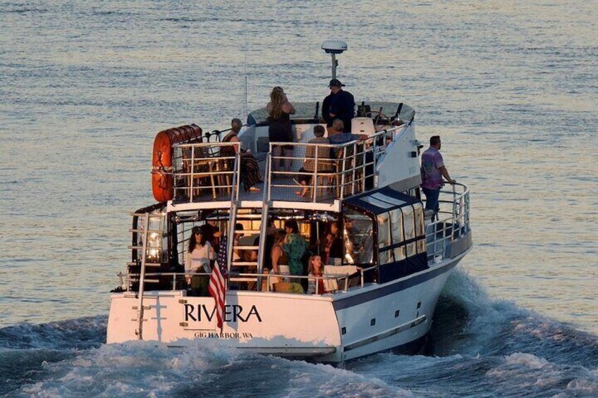 A boat named RIVERA cruising on the water. 2