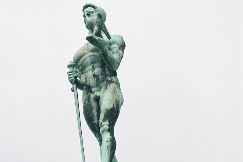 A bronze statue of a muscular figure holding a spear. 2